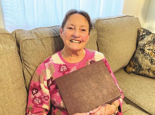 ODA LEE WEATHERRED was impressed with the Holdenville community when she first arrived in 1950. She has stayed involved and continues to care about what is happening to our community. She is shown holding the thesis she wrote in 1966 for her master’s degree documenting the decline of Hughes County, with Holdenville in mind.