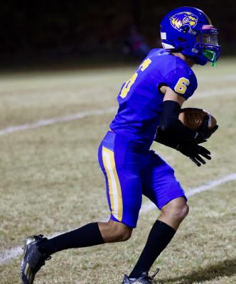 Holdenville defensive back # 6, Kase Sipes, took the ball away from a Davis ball carrier and raced toward the goal line. Sipes also threw a touchdown pass to help the Wolverines defeat Davis 22-15.