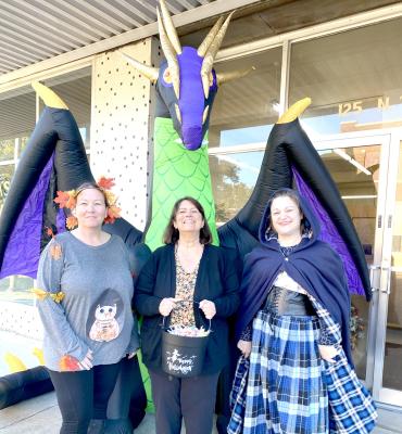 EVEN THE DRAGON OF ATLAS ABSTRACT EMERGED FROM THE BASEMENT FOR DOWNTOWN TRICKOR- TREATING! Pictured above are Alicia Mills, Diane Lankford, and Erin Chaffin.
