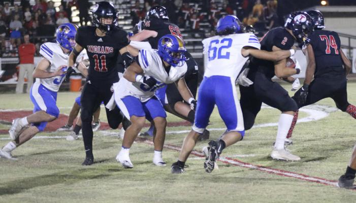 Holdenville defensive tackle # 62 Donovann Gibbs, grabs a Tishomingo running back while # 50 Julius Jackson and # 9 Cash Carter close in to help. The Holdenville defense dominated the Tishomingo offense in the Wolverines 42-8 victory.