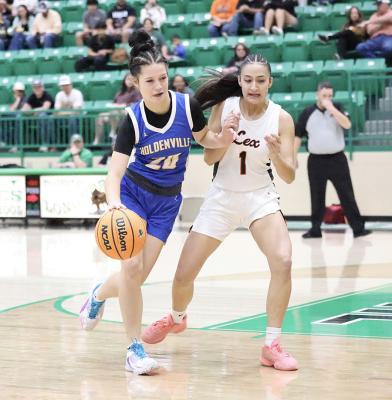 Dixie Gamble drives by a Lexington defender on her way to score two points for the Wolverines.