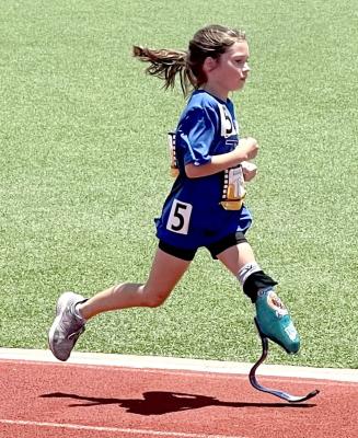 A young para-athlete sprints to finish strong in the 800 meter run. The young runner was one of many athletes that competed in the Endeavor Games at UCO.