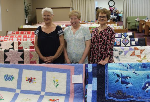 THE FIRST CHURCH OF GOD IN HOLDENVILLE AS WELL AS MEMBERS OF TEXAS BANNER CHURCH OF GOD IN HORNTOWN displayed several of their members’ handmade quilts. Pictured above with their quilts are (L-R): Susie Brittain, Brenda Lunsford, and Melba Cook.