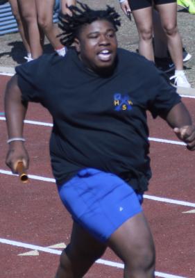 Holdenville shot-putter, Dierre Olden, sprints to the finish line in the weight-man’s relay at the conference in Chandler. The big guys won a medal in the