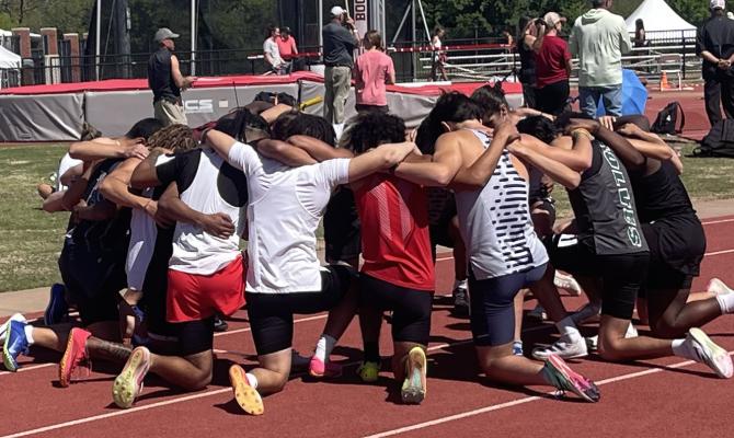 This group of athletes paused to pray before their race! The group was competing at the John Jacob’s Invitational at the University of Oklahoma.