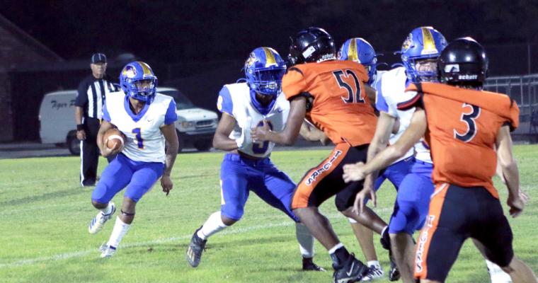 Holdenville quarterback, # 1 Izaiah Kingheads upfield behind the blocking of # 3 , Malachi Henderson and # 9, Cash Carter. Holdenville defeated the tigers 53-0.