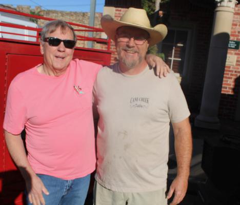 FORMER HOLDENVILLE RESIDENTS Clyde Leach and Jim McGill were in town for Fall Festival. Both ended up in the food business. Jim preparing it, and Clyde eating it.