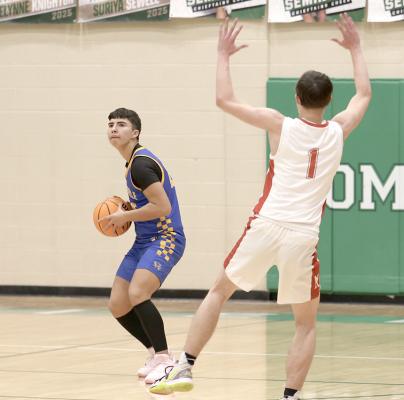Holdenville’s Brett Bruner made this Mc-Loud defender do a strange dance step when he launched a long distance shot before the buzzer that ended a quarter, Bruner and the Wolverines will host Prague on Friday.