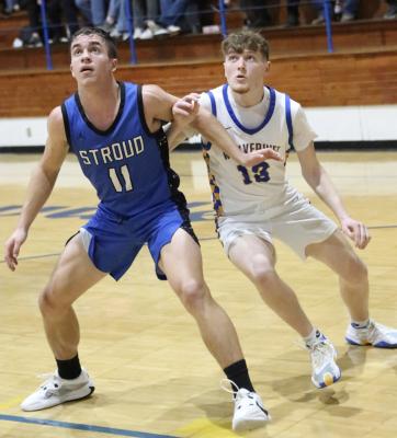 Holdenville Wolverine big man, Gage Smith, fights with a Stroud defender for rebound position. The Wolverines defeated the Tigers 70-54.