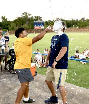 Holdenville Head Football Coach, David Barker, took one for the team at the annual Wolverine Pie Auction. Wolverine lineman, Aaron Torres was all smiles as he presented his coach with a pie!