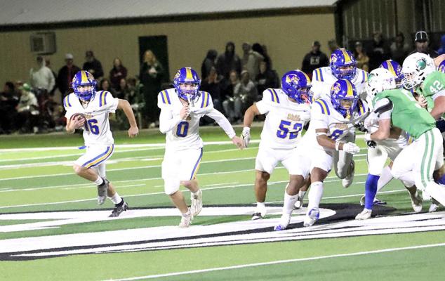 Holdenville running back # 16, Memphis Thionnet runs behind the blocking of # 0, Abe Gomez,# 52, Aaron Torres,# 8, Joe Remis and # 55 Brayden Black for a good gain.