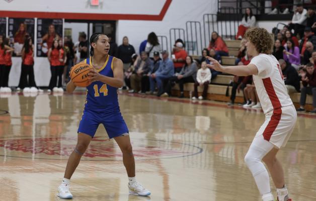 Holdenville’s Xavier Randall looks to pass in the Wolverine’s win at McLoud. Holdenville will compete in the Konawa Tournament on Thursday.