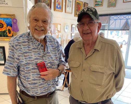 Enjoying refreshments at the HSPS Spring Art Show were Stephen Davis and Dale Gann.