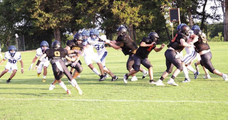 One problem with keeping score in scrimmages is that turnovers and penalties don’t hurt you. Also there’s no kicking game......The Wolverines will travel to Wewoka this Friday for their season opener.... (notice the obvious holding in the middle).