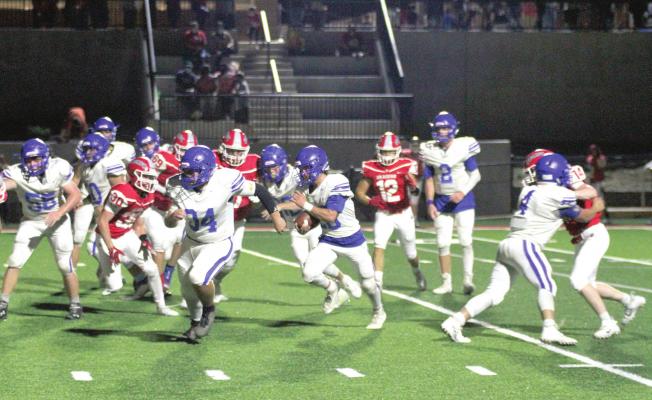 Touchdown run.....Wolverine running back # 20, Tatum Sanford, heads to the end zone with a herd of Holdenville blockers. Wolverine blockers # 4, Christian Zambrano, # 34 Isaiah Buck and # 62 Cody McFarland cleared the way for Sanfords touchdown run.