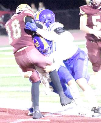 The best pass defense is to sack the quarterback before he can release the pass! These two Wolverine defenders put the Wampus Cat quarterback on the ground before he could throw.