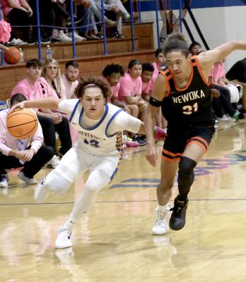 Holdenville guard, Wyatt Seeley, dribbles around a Wewoka defender on his way to the basket. Holdenville will take a few days off before competing in the Dell City Festival December 27-28.