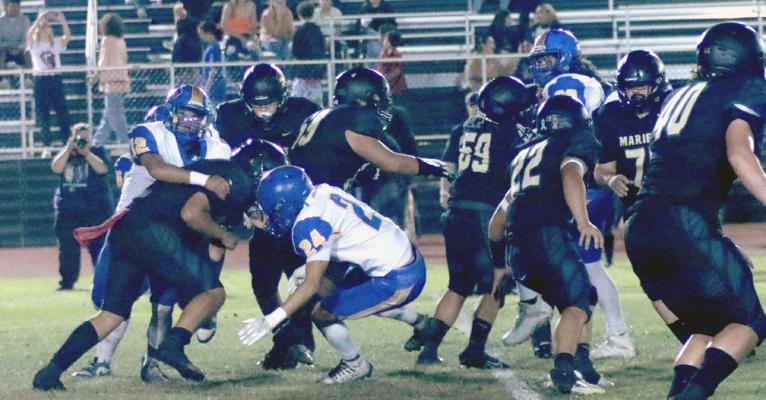Holdenville linebackers # 12, Bubbah Bowen and # 24, Xavier Randall pushed all of these Marietta blockers out of their way and converged on the Marietta Indian running back. Holdenville won the game 52-0 and will travel to Lexington for an important district contest on Friday.
