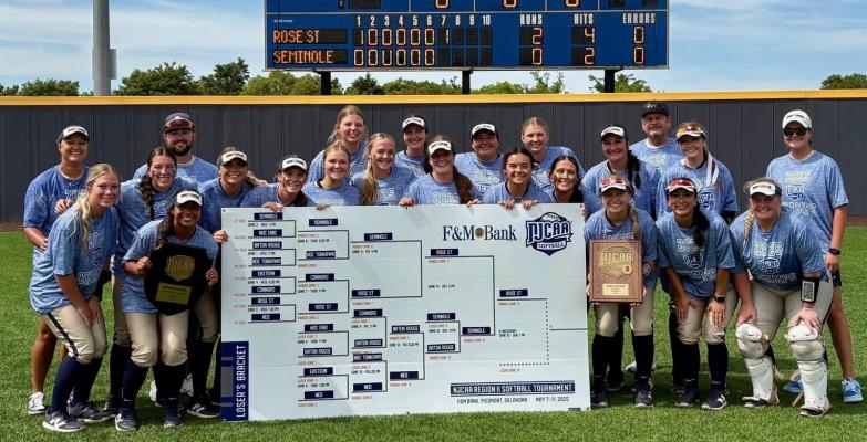 The Rose State College Raiders defeated all rivals on their journey to the NJCAA World Series. Note the team names and the score on the score board behind the team picture.