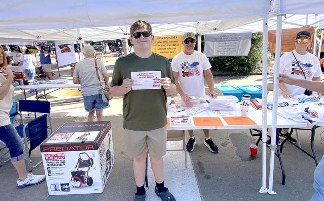 Wyatt Stafford stops to place his vote for “Kids Choice” in the car show.