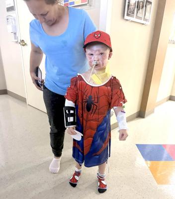 Ryker Corona, dressed in a Spiderman costume, takes a walk at Integris Baptist Hospital in Oklahoma City where he is undergoing treatment for second degree burns he sustained in an explosion at the Jasmine Moran Children’s Museum on Saturday, June 21. (Photo Courtesy of Seminole Producer)