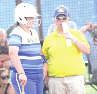 Holdenville Head Softball Coach talked things over with Bailee Black before Bailee took her turn at bat against the Valliant Bulldogs.
