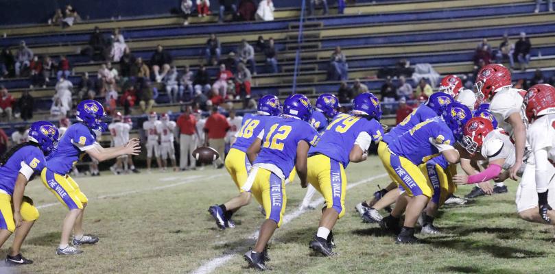 Holdenville Bravo Quarterback # 9, Rowdy Elkins takes a snap while # 5 ,Kejo Watson waits for a handoff. Holdenville’s # 12, Jordan Harjo, # 79, Chase Foraker, # 18,Laden Yates, # 64, Trey Carter and # 14 Xavier Randall clear out the opposition. Holdenville defeated Comanche 40-7 to finish the season with a perfect 10-0 record.