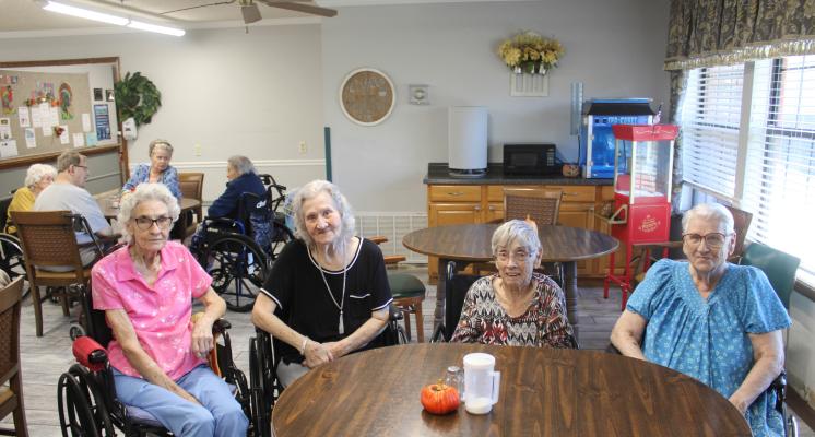 LONGTIME FRIENDS AND HOLDENVILLE RESIDENTS AT HERITAGE VILLAGE WERE HAPPY TO ENJOY THE VETERANS DAY PROGRAM AT THE NURSING HOME. Pictured above are Ozelle Youngblood, Nina Wainscott, Sue Moore, and Dortha Morris.