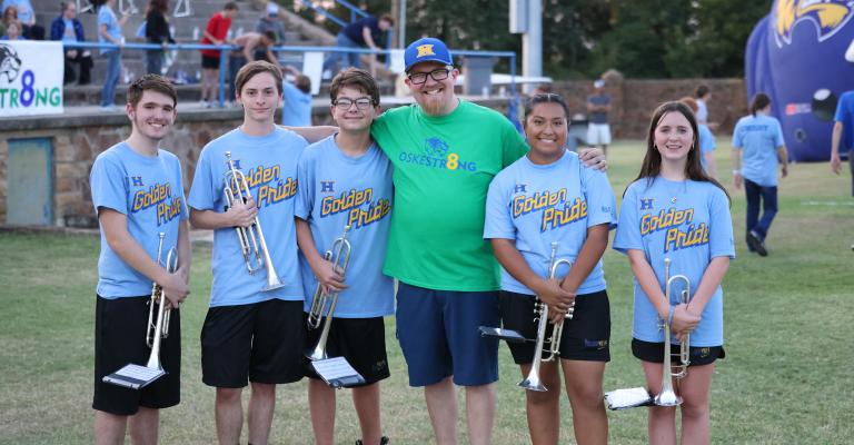 HOLDENVILLE BAND DIRECTOR, SAM CROSBY, WAS BEAMING WITH PRIDE AFTER HIS TRUMPET SECTION DID AN AMAZING JOB DURING THE PLAYING OF THE NATIONAL ANTHEM. The Golden Pride trumpet players are:(L-R) Tony Caudell, Dallas Davenport, Cale Babb, Golden Pride Director Sam Crosby, Liliana Gonzalez and Emily Goodman.