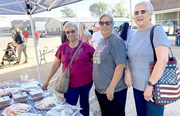 Sue Giles, Nancy Conley and Vickey Mackey stop for a sweet treat at this year’s Fall Festival.
