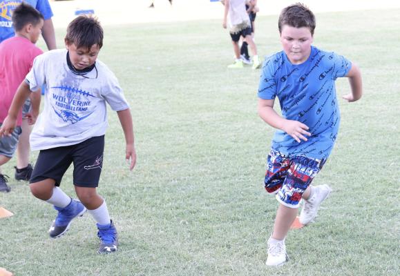 Michael Merriman and Marty Gastins put in some hard work at the USA Little League’s football camp. The camp had over 60 participants and the coaches were able to teach the players some basic football skills.