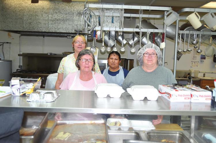 ALTHOUGH SENIOR CITIZENS CANNOT GO INTO THE NUTRITION SITE BUILDING DUE TO THE VIRUS, the cooks make sure that they are still being fed. The crew pictured above are serving almost 100 meals each day and we appreciate their dedication. Pictured are (front) Teresa Loch and Renee Garvin. (back) Lilah Petsemoie and Lori Long.
