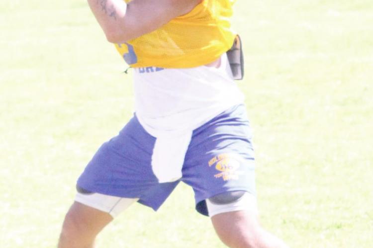 Holdenville quarterback, Devon Tiger, took his turn in one of the pre-season drills in a practice session last week. The Wolverines will open the season next week with the Wewoka Tigers.