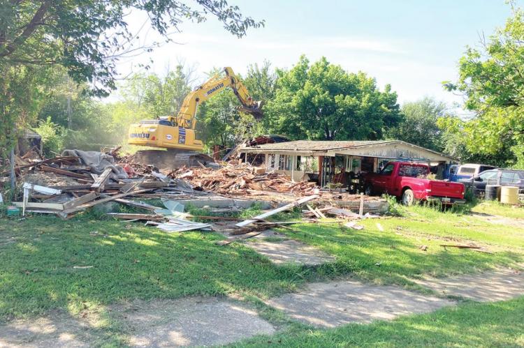 TEAR DOWN – The abandoned house at 122 S. Bullitt is now a vacant lot after the structure was torn down Monday morning. This is part of a long running program to clear out the abandoned and dilapidated structures in Holdenville. A new list of houses is currently awaiting approval for tear down from the DEQ.