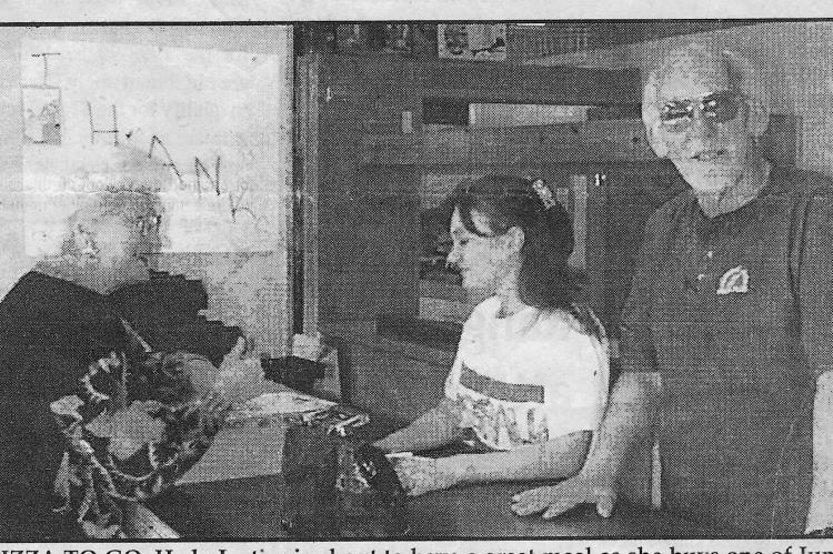 Looking Back around 1992—PIZZA TO GO. Hedy Justice is about to have a great meal as she buys one of Jumpin’ Jack’s delicoius pizzas from co-manager Jennifer Bleeker and owner Jack Holmes. Jumpin’ Jack’s Pizza will soon be open in a brand new location, but the pizza, spaghetti and sandwiches will stay as good as they are now.