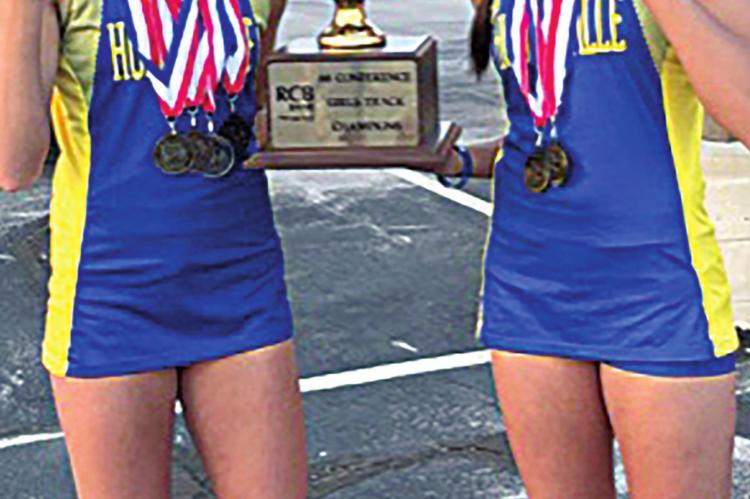Leigha and Laynee Phillips proudly hold the 66 Conference Championship Trophy the team won in 2019. Leigha and Laynee both won regional championship medals in 2019.