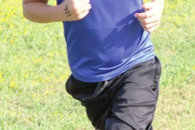 ABOVE—Holdenville Elementary runners Aiden Story finished 14th, Brently Krause finished 15th, Rowdy Rhine finished 17th.