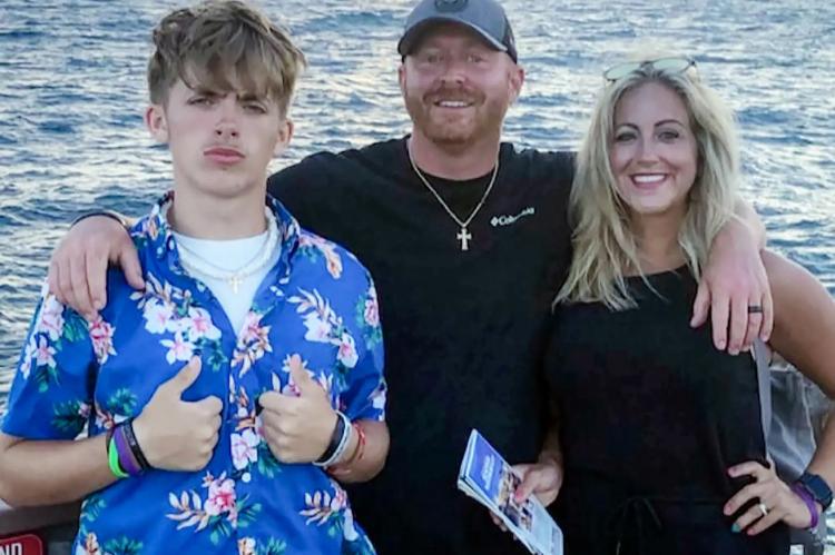 (L–R) Bryce Tate poses with his parents, Adam and Amanda, in this file photo. The 15-year-old took his own life in November 2025 after an hours-long exchange with an online predator. Courtesy of Adam Tate