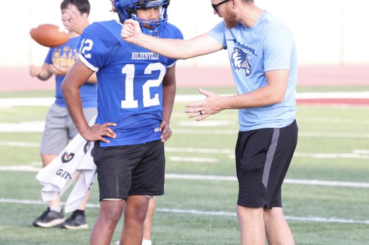 Holdenville assistant coach, Allan Hargis, gives instruction to a young defensive player during the Wolverines’ football camp at Atoka. The Wolverines are busy this summer preparing for the 2024 season.