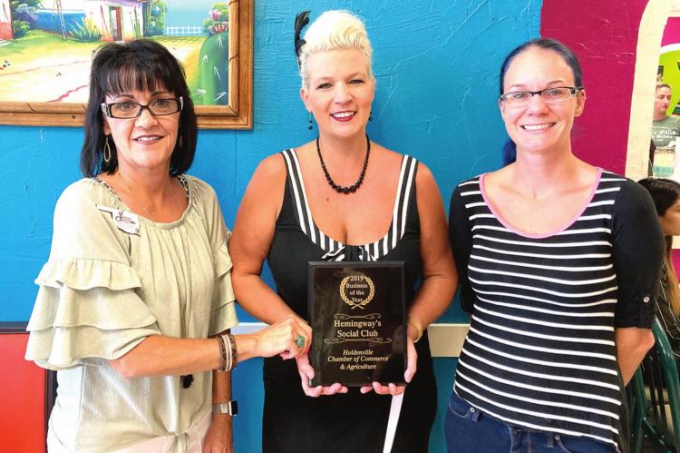 Hemingway’s Social Club & Neighborhood Bar Business of the Year Miranda Freeman accepts award with Nancy Hall
