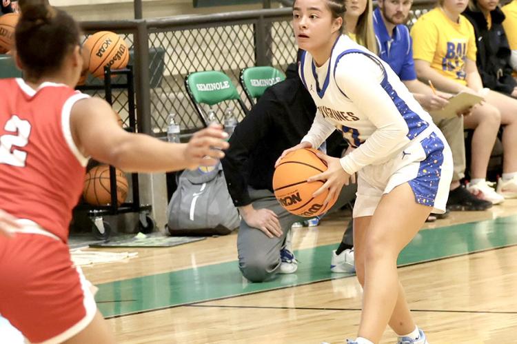 Wolverine guard, Lexxi Goolsby, Looks to pass around a McLoud defender. Holdenville will celebrate “Homecoming 202425” this FRiday when the Wolverines host Prague.