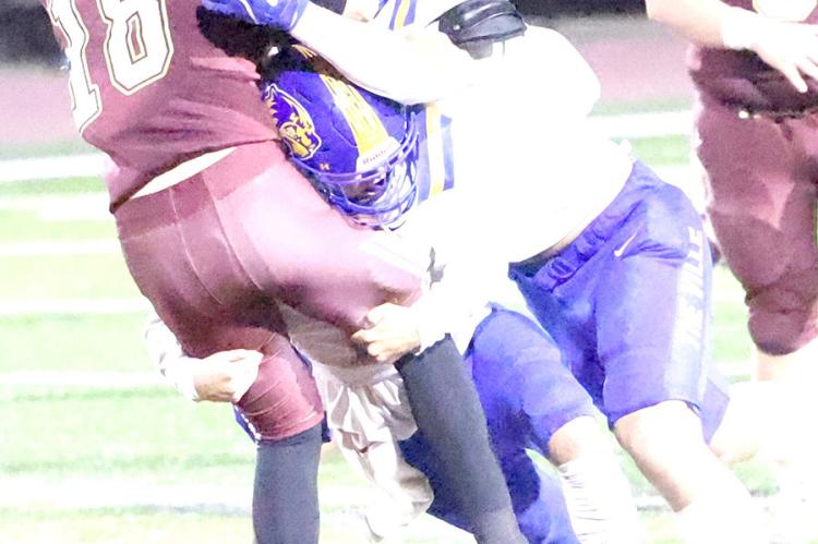 The best pass defense is to sack the quarterback before he can release the pass! These two Wolverine defenders put the Wampus Cat quarterback on the ground before he could throw.