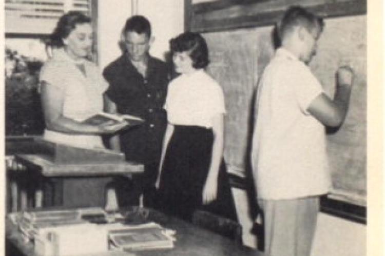 1956 HHS Annual - Three freshmen students, Jack Holmes, Judy Adams and Larry Ramsey getting a little extra help on an algebra problem from Mrs. Foote.