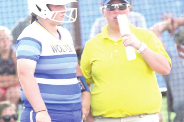Holdenville Head Softball Coach talked things over with Bailee Black before Bailee took her turn at bat against the Valliant Bulldogs.