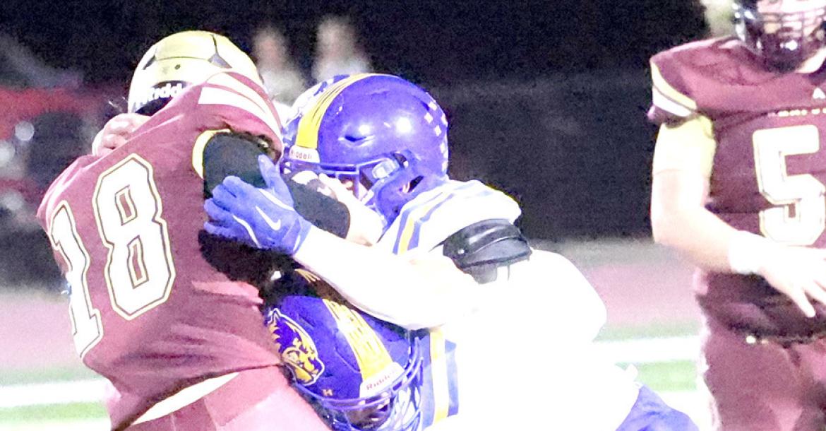 The best pass defense is to sack the quarterback before he can release the pass! These two Wolverine defenders put the Wampus Cat quarterback on the ground before he could throw.