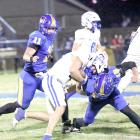 Holdenville defenders # 11 Tank Redmond and # 18 Landen Yates brought down this Hartshorne running back for a loss.